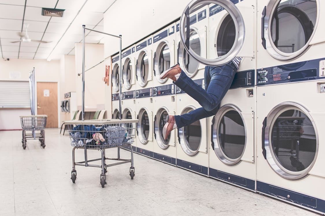 woman in a laundromat inside a dryer