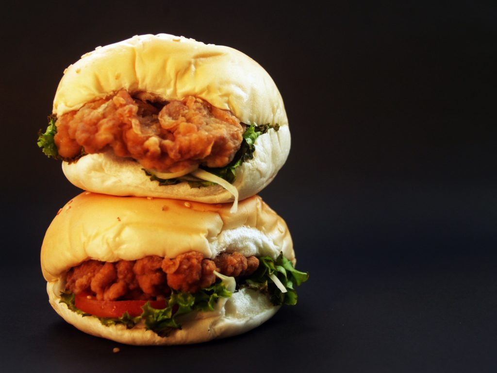 two chicken sandwiches stacked on top of each other