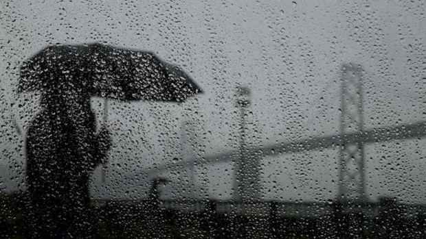 silhouette of woman with umbrella in the rain